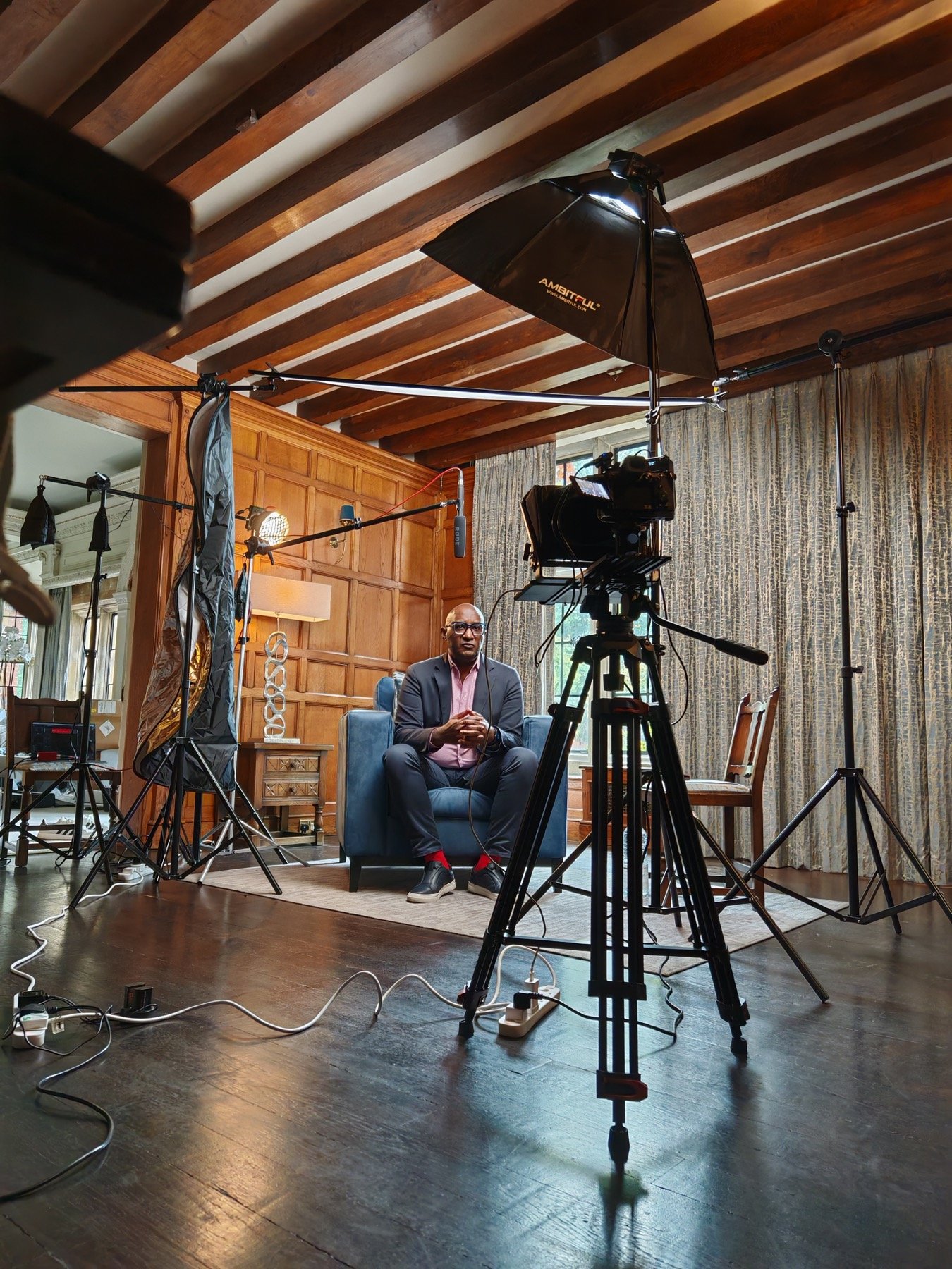Wide behind the scenes room setup with camera and lights
